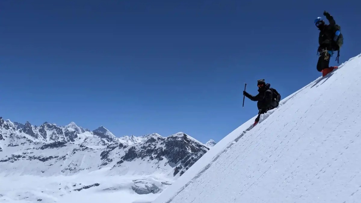 Trekkers climbing through snow on the Deo Tibba trail