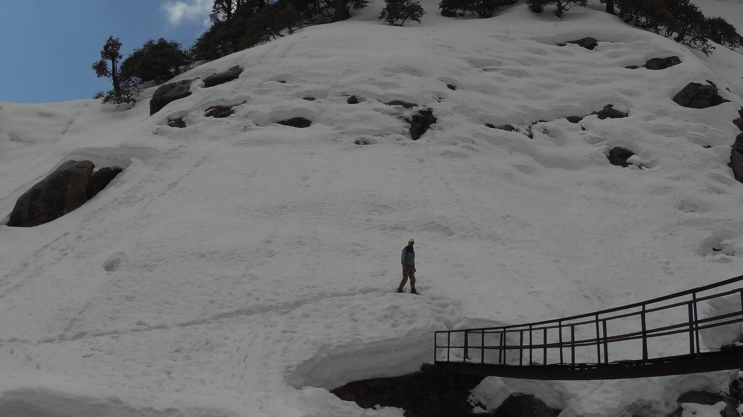 Snow-covered Kareri Lake trail with a bridge