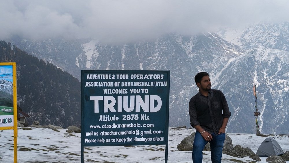 Triund trek sign and mountain landscape